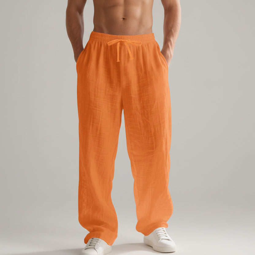 Men wearing solid color linen casual pants with loose fit and wide legs for summer beach wear