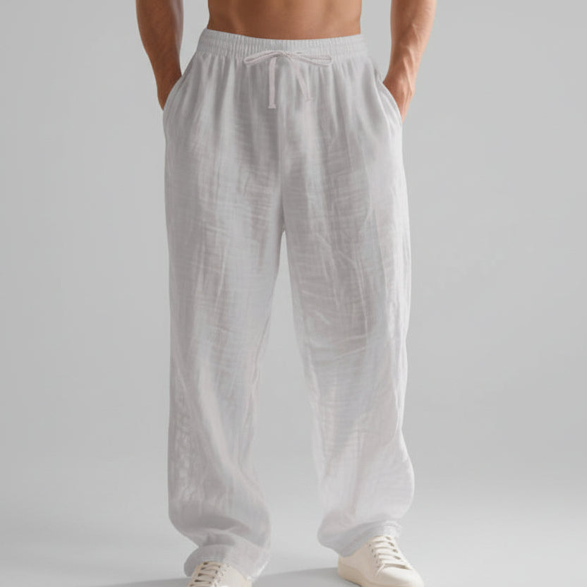 Men wearing solid color linen casual pants with loose fit and wide legs for summer beach wear
