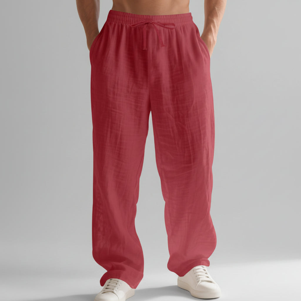 Men wearing solid color linen casual pants with loose fit and wide legs for summer beach wear