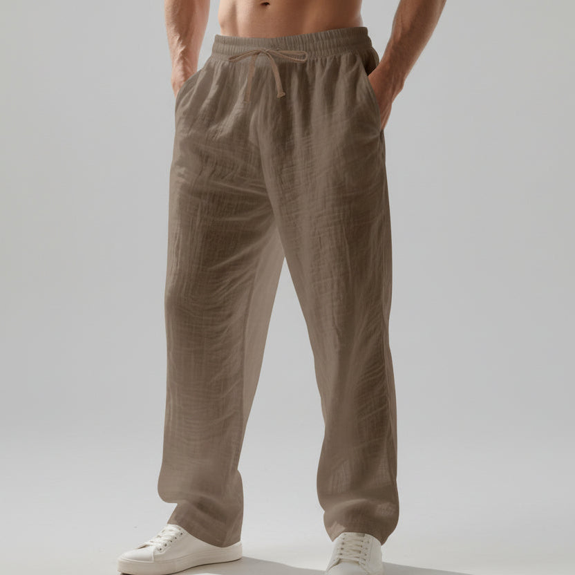 Men wearing solid color linen casual pants with loose fit and wide legs for summer beach wear