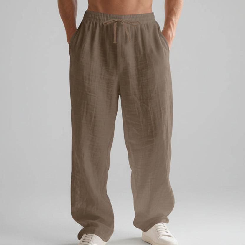 Men wearing solid color linen casual pants with loose fit and wide legs for summer beach wear