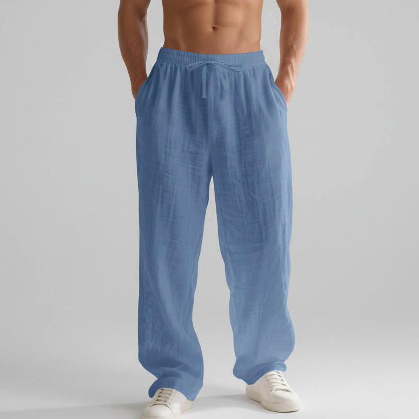Men wearing solid color linen casual pants with loose fit and wide legs for summer beach wear
