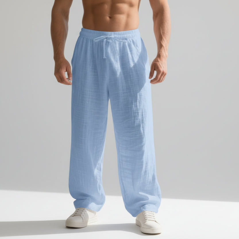 Men wearing solid color linen casual pants with loose fit and wide legs for summer beach wear