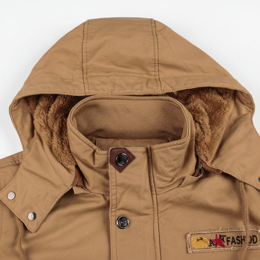 Close-up of a brown hooded jacket with fur lining on a white background